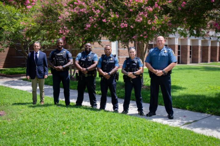 Group of Henrico County Police Officers in uniform and one in business attire.