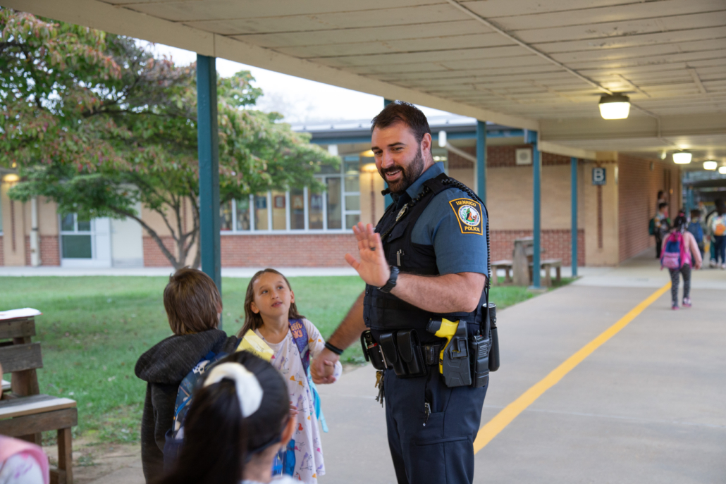 Henrico Police School Resource Officer high fives a student.